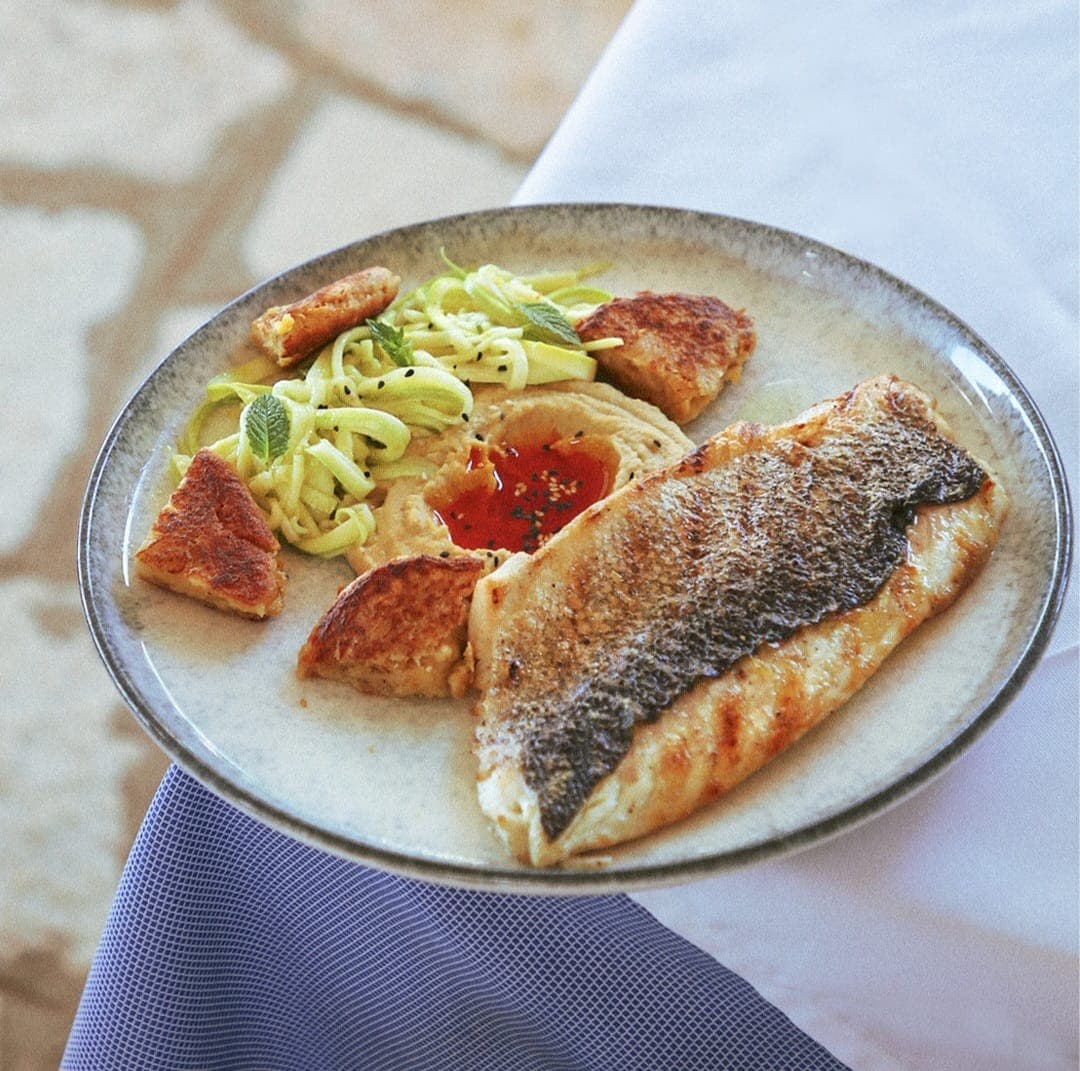 Pan-seared sea bass with hummus and zucchini