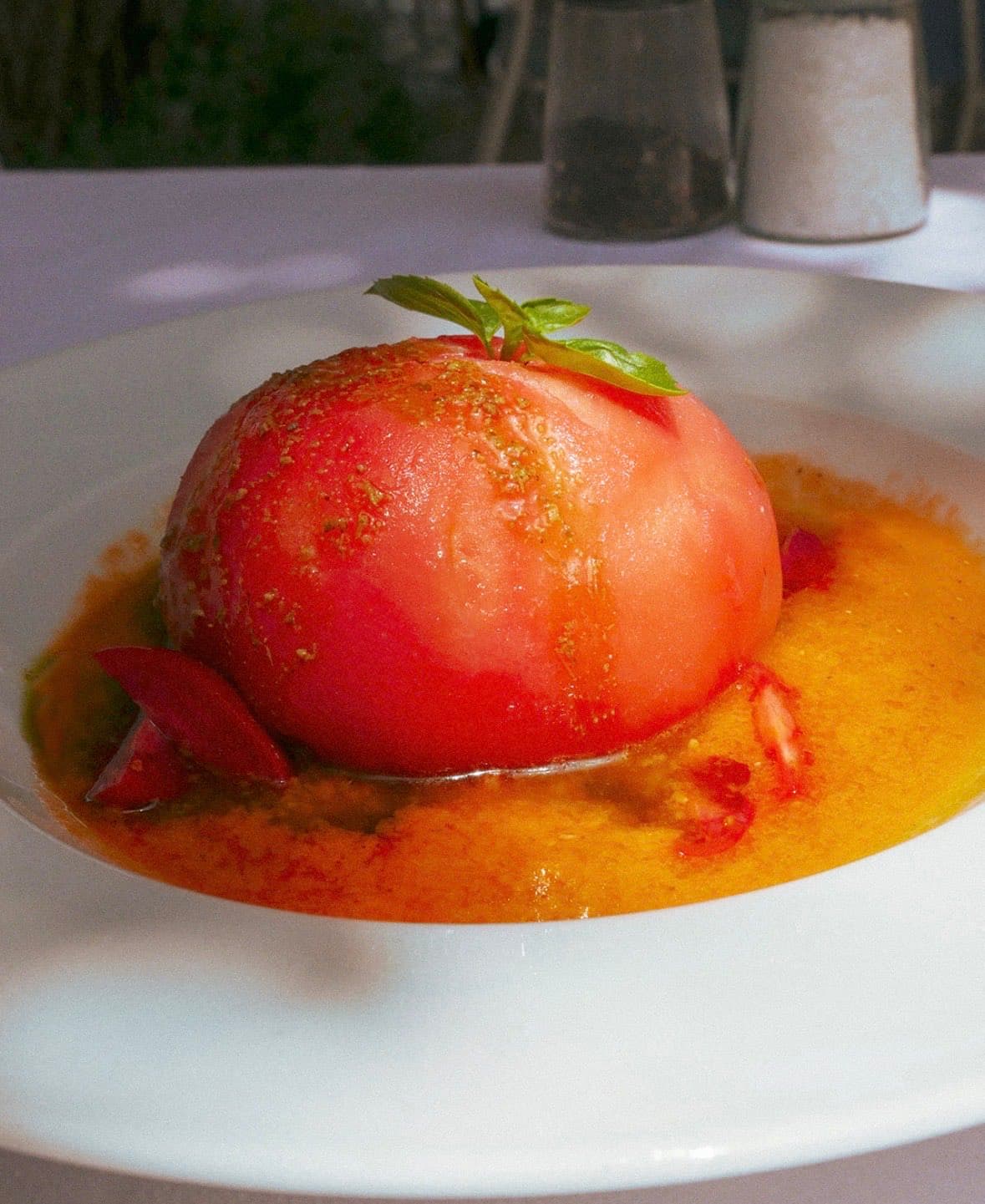 A sun-ripened tomato, slow-cooked and dressed at the table