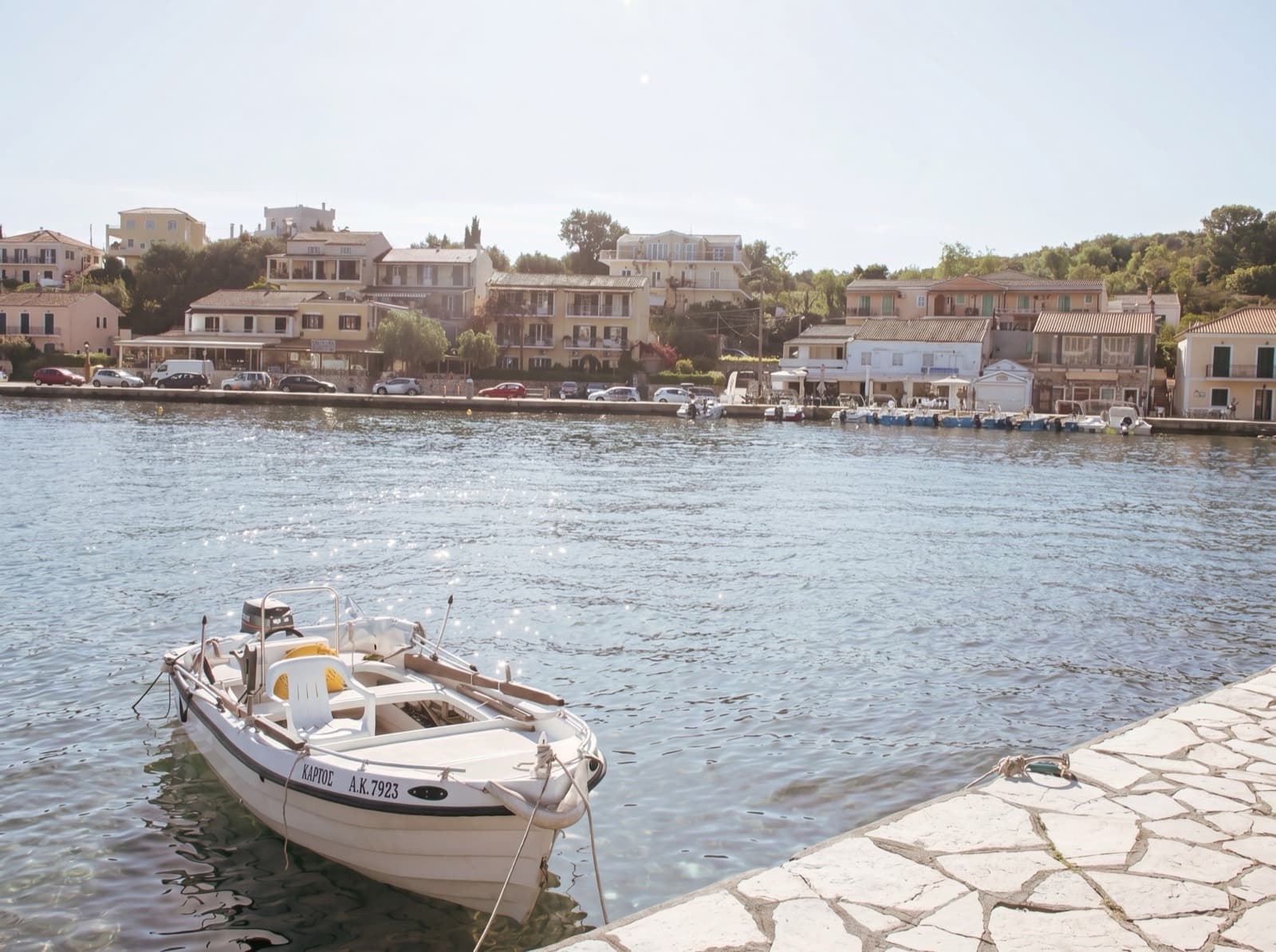 Kassiopi harbour — Porto Nuovo, a table by the sea, Corfu